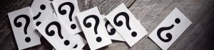 question marks on gray wood background for blog differences between copyright trademark and patents by kelley way attorney walnut creek